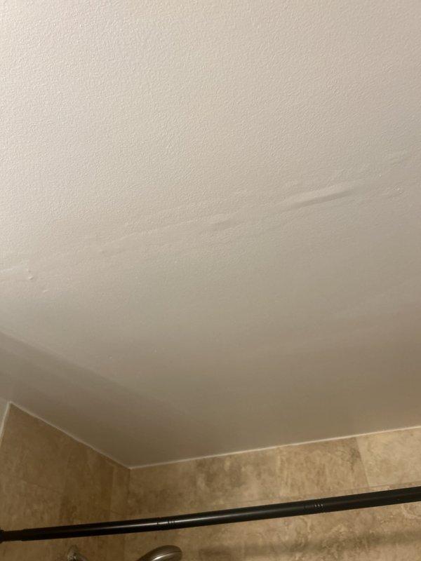 Responded to water leak investigation request for moisture damage visible on ceiling surfaces in hallway and multiple bathrooms. Conducted thorough inspection of affected areas and created ceiling access point to examine plumbing lines and identify source of water intrusion. Visual assessment revealed water staining patterns consistent with potential pipe leak above ceiling plane, documented conditions with photographic evidence for further evaluation and repair recommendations.