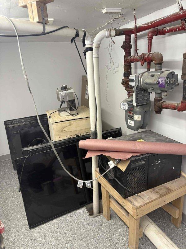 Performed comprehensive camera inspection and documentation of residential basement mechanical systems. Documented heating system installation including floor-mounted components with PVC venting, extensive copper piping network with circulator pump, control systems, and electrical connections. Captured HVAC condensing unit positioned on wooden platform with associated refrigerant lines, ductwork, and utility room infrastructure including fire safety equipment and drainage systems.
