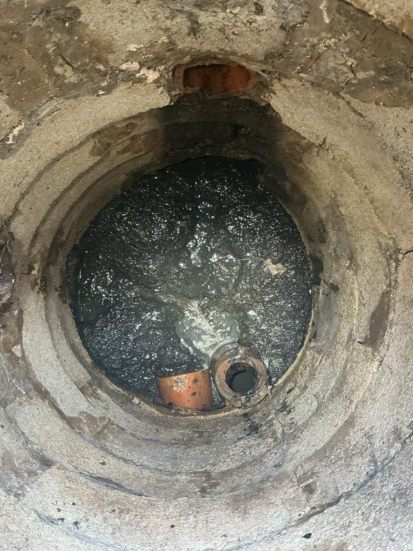 Performed comprehensive sump pit maintenance including pumping, high-pressure jetting, and camera inspection of circular concrete chamber. Pre-service documentation revealed significant water accumulation and debris at bottom of pit with visible drainage components partially submerged. Deployed pump truck to extract standing water and accumulated sediment, followed by hydro-jetting to clear blockages and restore proper drainage flow. Conducted video camera inspection to assess structural integrity and confirm all drainage lines were functioning properly after cleaning.