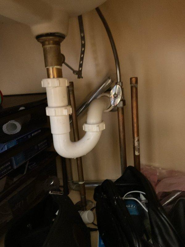 Responded to master bathroom sink drain clog causing water backup and overflow conditions. Accessed P-trap assembly beneath vanity sink and performed diagnostic inspection of drainage system. Cleared obstruction from drain line, reassembled plumbing components, and tested system to verify proper water flow and drainage functionality restored.