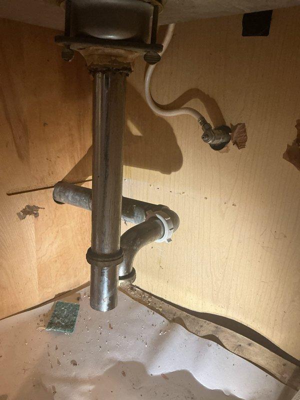 Replaced deteriorated chrome P-trap assembly under kitchen sink due to corrosion and potential leak concerns. Removed old trap fixture, cleaned drain connections, and installed new chrome-plated P-trap with slip-joint fittings to restore proper drainage function and prevent future water damage to cabinet interior.