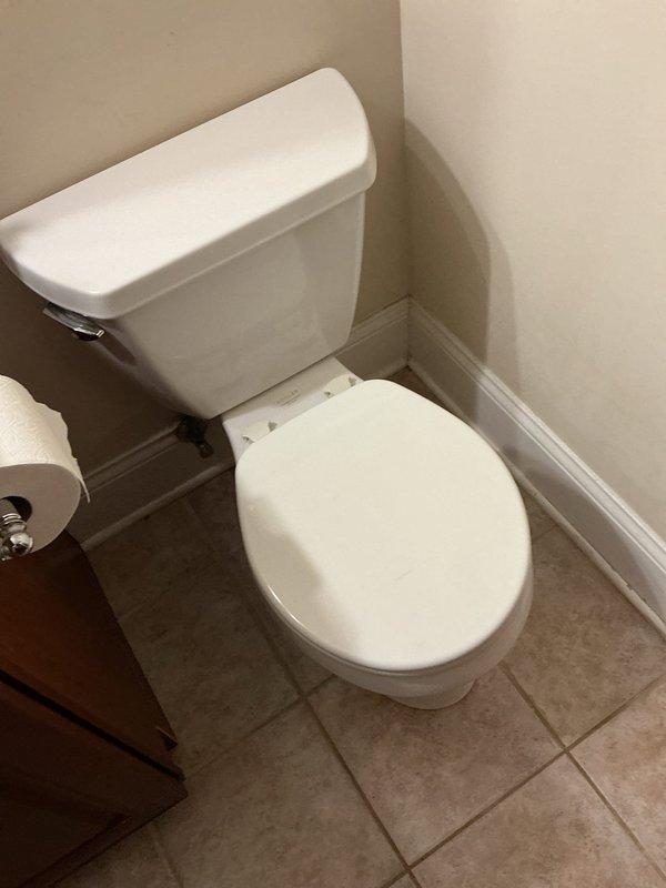 Completed toilet replacement in basement bathroom of 25-year-old residential property. Removed existing two-piece toilet fixture and installed new standard white porcelain toilet with tank and bowl assembly, ensuring proper sealing, secure mounting, and connection to existing water supply and drain lines. Verified proper flush operation and checked for leaks upon completion.