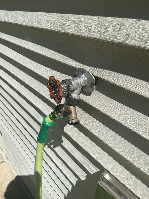 Conducted plumbing estimate for basement sink installation requiring new drainage system and water supply line connections. Evaluated existing plumbing infrastructure, including outdoor hose bib and unfinished basement utility area with exposed framing, copper piping, and PVC drain lines. Provided assessment for installing dedicated shut-off valve on water line serving exterior spigot to improve system control and facilitate future maintenance.