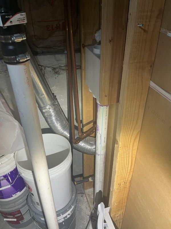 Conducted plumbing estimate for basement sink installation requiring new drainage system and water supply line connections. Evaluated existing plumbing infrastructure, including outdoor hose bib and unfinished basement utility area with exposed framing, copper piping, and PVC drain lines. Provided assessment for installing dedicated shut-off valve on water line serving exterior spigot to improve system control and facilitate future maintenance.