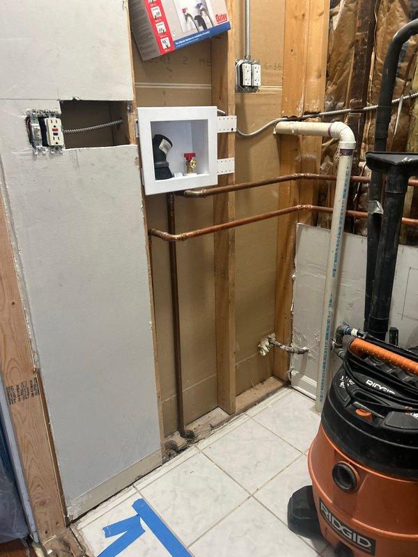 Completed plumbing rough-in installation for interior renovation project, routing copper supply lines and PVC drain/waste/vent piping through exposed wall framing. Installed vertical and horizontal pipe runs with proper fittings, elbows, and junction connections in accordance with code requirements, preparing the system for inspection and subsequent drywall closure.