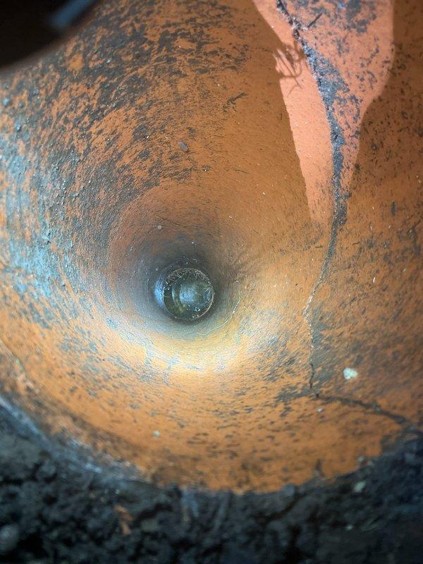 Responded to service call for broken external main sewer line cleanout. Conducted thorough inspection and documentation of the damaged cleanout assembly, revealing severe corrosion and deterioration of the cast iron pipe interior with extensive rust accumulation throughout the visible sections. Assessed the cleanout access point at ground level and documented the compromised condition of the pipe structure to determine scope of necessary repairs and potential requirement for interior drain system mapping to identify full extent of line damage.