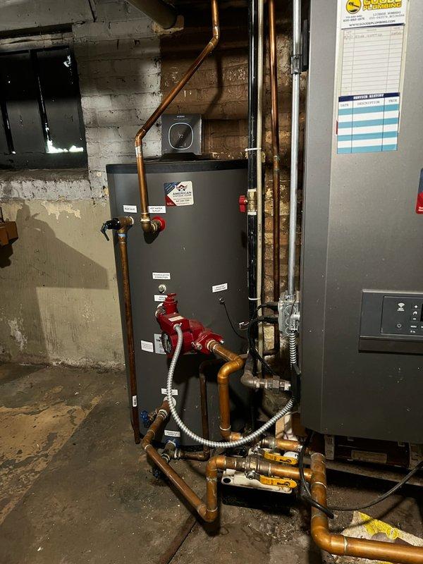 # Commercial Drain and Sewer Estimate Completed

Conducted a comprehensive drain and sewer system evaluation in a commercial basement mechanical room housing water heating and HVAC equipment. The assessment documented existing plumbing infrastructure including copper piping, brass valves, pressure gauges, flexible metal connectors, and associated mechanical systems to provide accurate estimate specifications for proposed drain and sewer work.
