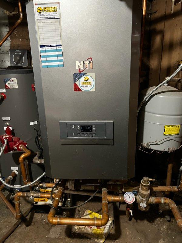 # Commercial Drain and Sewer Estimate Completed

Conducted a comprehensive drain and sewer system evaluation in a commercial basement mechanical room housing water heating and HVAC equipment. The assessment documented existing plumbing infrastructure including copper piping, brass valves, pressure gauges, flexible metal connectors, and associated mechanical systems to provide accurate estimate specifications for proposed drain and sewer work.
