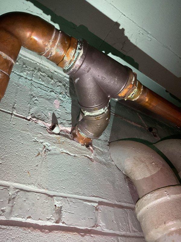Performed annual kitchen stack line jetting service for commercial building after receiving complaints of kitchen sink backups in units 301 and 101 on the 01 stack. Inspected and documented the east (rear) kitchen stack joint, identifying dissimilar metal connection where a non-copper joint was installed in the copper stack system, causing galvanic corrosion and internal deterioration. Successfully cleared the kitchen drain line and provided detailed explanation of the corrosion issue to building management for future remediation planning.