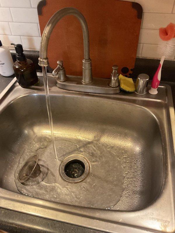 Responded to priority service call for slow-draining kitchen sink. Upon inspection, cleared blockage from drain line and tested water flow to confirm proper drainage. Verified P-trap assembly and connections were secure with no leaks present, ensuring full restoration of normal sink function.