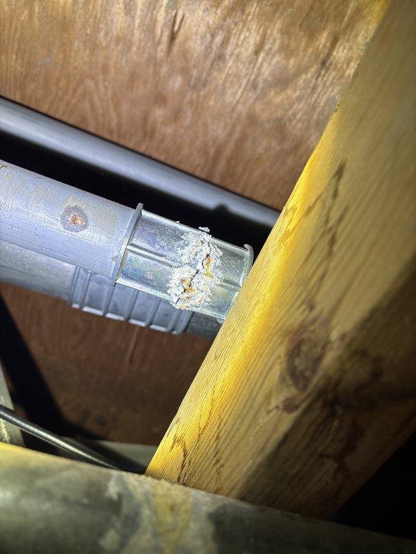 Responded to commercial property for reported water leak in ceiling caused by galvanized pipe joint failure during rain events. Upon inspection, located deteriorated galvanized piping in ceiling space showing significant corrosion and oxidation at joint connections. Documented existing conditions with photographs showing advanced corrosion on metal ductwork and piping secured to building exterior and interior structural members. Provided assessment and recommendations for repair or replacement of affected galvanized piping system to eliminate water intrusion issue.