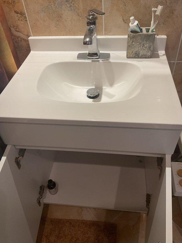 Successfully installed new bathroom vanity with integrated white countertop, single-handle chrome faucet, and pop-up drain assembly, including complete P-trap connection and cabinet mounting. Installed new dual-flush toilet with elongated bowl and soft-close seat, ensuring proper wax ring seal and water supply connection. All fixtures tested for proper operation and verified leak-free performance upon completion.