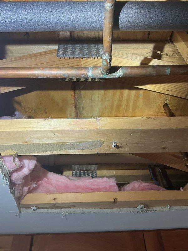 Responded to copper piping issue in kitchen of 15-year-old residential property. Performed comprehensive repipe service, replacing deteriorated copper supply lines throughout affected areas. Installed new copper piping with proper support and insulation, integrated with existing HVAC system components in attic space. Verified all connections at water meter, pressure gauge, and main shutoff valves for proper flow and pressure. System tested and confirmed operational with no leaks detected.