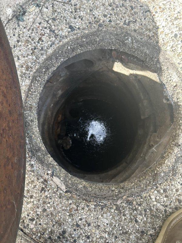 Responded to service call for toilet not flushing properly. Upon inspection, found toilet bowl retaining dark water indicating drainage obstruction. Investigated drain line and identified blockage in main waste line beneath fixture. Cleared obstruction from drainage system to restore proper flow and flushing function. Verified toilet operation and confirmed complete drainage after repair.