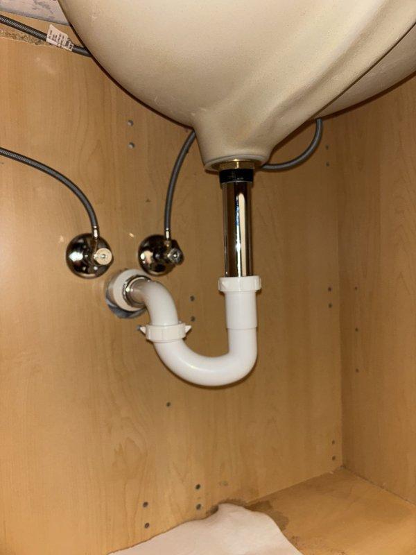Responded to service call for failed water heater with active leak at base of unit. Upon inspection, confirmed approximately 5-6 year old tanked water heater was leaking from bottom, indicating internal tank failure. Documented existing plumbing configuration including water supply connections and drain assembly. Photographed failed unit and surrounding plumbing infrastructure for estimate preparation. Advised replacement of water heater due to base leak, which typically indicates corrosion or tank breach that cannot be repaired.