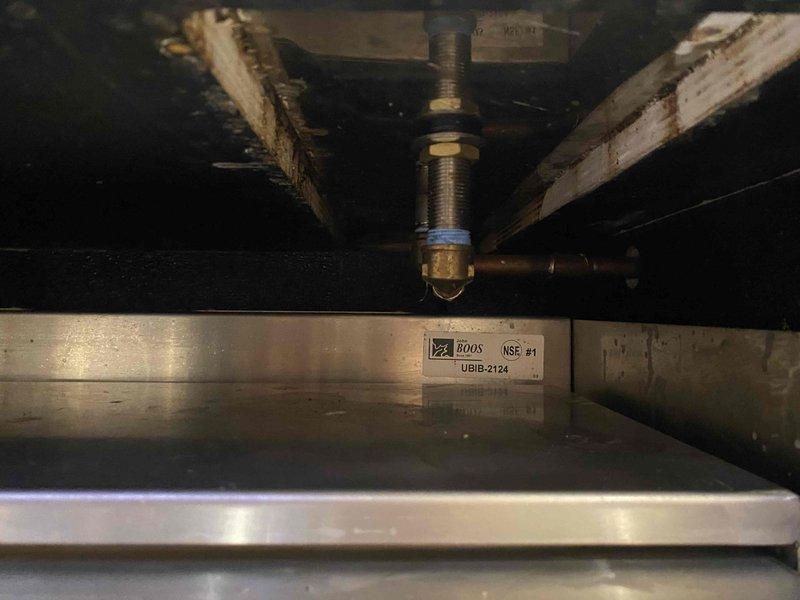 Responded to warranty callback for previously repaired plumbing beneath commercial coffee service counter. Upon inspection, identified recurring leak at drain connection under counter and documented condition of brass fittings and copper piping showing moisture exposure. Assessed plumbing infrastructure mounted to stainless steel commercial food service equipment and photographed affected areas for warranty documentation.