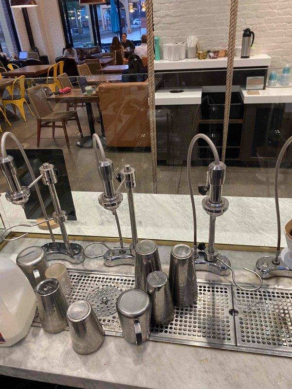 Responded to warranty callback for previously repaired plumbing beneath commercial coffee service counter. Upon inspection, identified recurring leak at drain connection under counter and documented condition of brass fittings and copper piping showing moisture exposure. Assessed plumbing infrastructure mounted to stainless steel commercial food service equipment and photographed affected areas for warranty documentation.