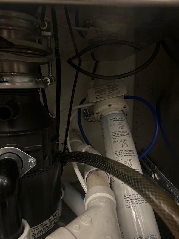 Conducted comprehensive plumbing assessment identifying multiple system concerns requiring attention. Evaluated existing sump pump and determined replacement necessary due to operational failure. Inspected main sewer line and recommended power rodding and flushing to address drainage issues. Assessed water quality needs and provided estimate for whole home filtration system installation at main water valve location. Documented existing mechanical room infrastructure including current water treatment equipment, copper supply lines, HVAC ductwork, and utility space configuration to support proposed system upgrades.