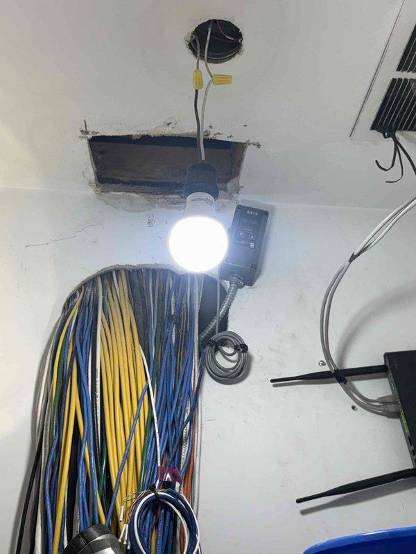 Responded to active water leak originating from kitchen area and penetrating into utility closet below. Upon arrival, customer reported slow leak that had previously caused staining but recently progressed to active water intrusion. Created access openings in utility closet ceiling to locate source of leak and assess plumbing infrastructure. Installed temporary work lighting to facilitate inspection of concealed plumbing systems and electrical components in ceiling cavity. Identified leak path through floor assembly and traced water migration from kitchen plumbing above. Documented existing conditions including compromised ceiling materials, exposed framing, and water damage patterns. Inspected mechanical systems, piping, and structural components within affected areas to determine extent of water intrusion and potential secondary damage.