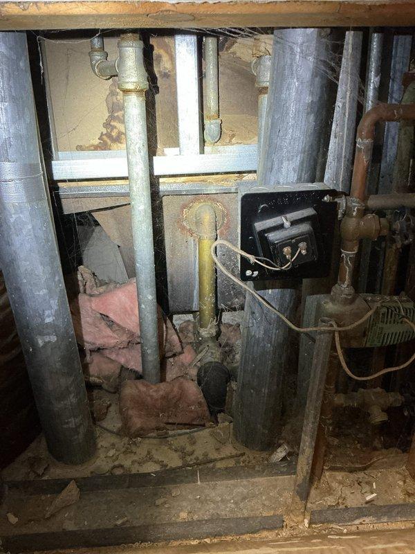Responded to report of leak from tub faucet. Upon inspection, identified active leak at tub spout and noted missing shower valve handle/trim. Accessed crawlspace beneath bathroom to assess plumbing infrastructure and check for additional water damage or leakage points. Documented existing conditions including aged galvanized and copper supply lines, deteriorated insulation, and signs of prior moisture intrusion in subfloor area. Provided liability insurance documentation to building management as required. Photographed affected fixtures and underlying plumbing system for estimate preparation.