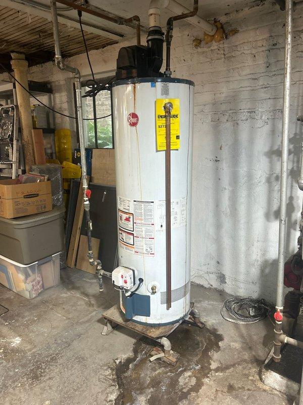 Responded to no hot water complaint and performed on-site assessment of 15-year-old tank-style water heater. Upon inspection, found unit with visible water leakage at base and extensive moisture damage on surrounding concrete floor, indicating tank failure. Documented existing conditions including deteriorated water heater with compromised tank integrity, corroded connections, and active water seepage. Provided comprehensive estimate for water heater replacement including removal of failed unit, installation of new tank-style water heater with appropriate capacity, connection of water supply lines, gas line hookup, venting configuration, and code-compliant installation per manufacturer specifications.