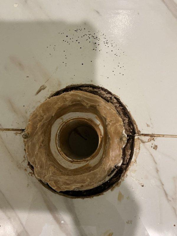 Completed installation of bathroom fixtures including drain assembly and associated hardware. Addressed existing wear and staining around the tub drain area, ensuring proper seating and seal of the drain components. Verified all connections are secure and functioning correctly with no leaks detected during testing.