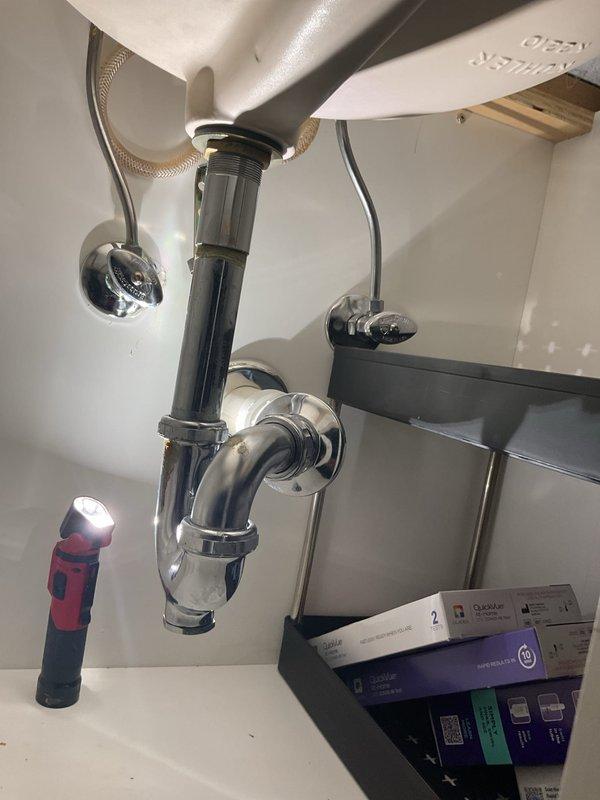 Installed customer-supplied kitchen faucet to resolve extended hot water delay and low water pressure issues at the sink. Addressed small leak at bathroom sink drain assembly and diagnosed low water pressure concern affecting the bathroom shower. Inspected and serviced plumbing connections under bathroom vanity, including P-trap, shut-off valves, and supply lines to ensure proper function and eliminate leak source.