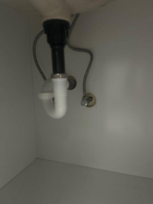 Completed post-inspection plumbing assessment for condominium unit, evaluating multiple minor plumbing concerns identified during home inspection. Inspected modern shower installation featuring dual showerhead system with matte black fixtures, single-handle valve control, and tub spout mounted on marble-effect tile surround with black-framed glass enclosure. Assessed shower drain assembly and provided estimate for replacement of drain cover components. Examined under-sink plumbing assembly including disposal unit connection, P-trap configuration, and associated drainage connections to ensure proper function and code compliance.