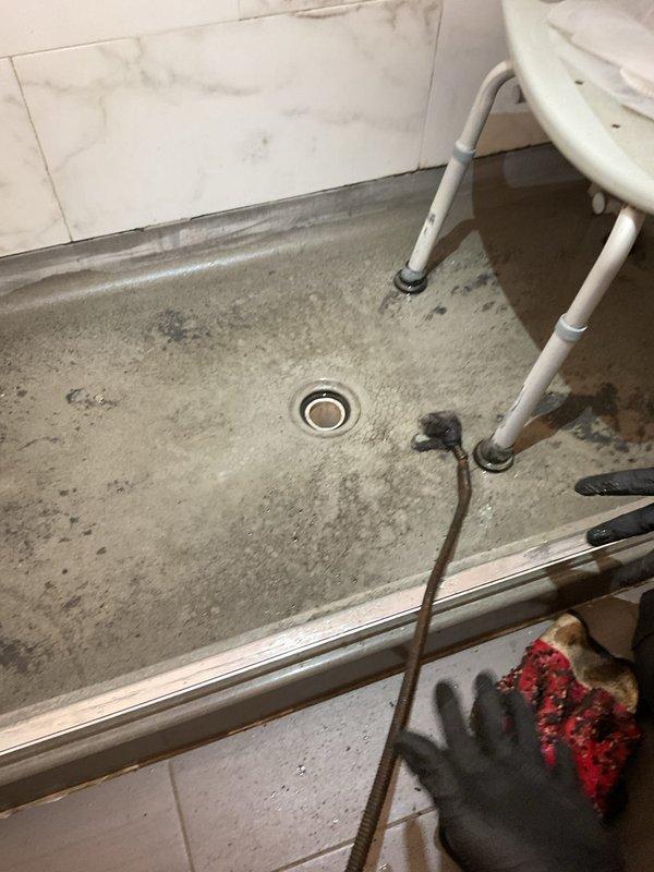 Responded to service call for kitchen sink draining slowly in 60-year-old home. Upon arrival, inspected under-sink plumbing and identified standard P-trap configuration with white PVC pipes and connections. Removed and cleared P-trap assembly of accumulated debris and buildup causing the slow drainage. Inspected drain lines for additional blockages and verified proper water flow. Reassembled all plumbing connections, checked for leaks, and tested sink drainage to confirm issue resolved. All components functioning properly upon completion.