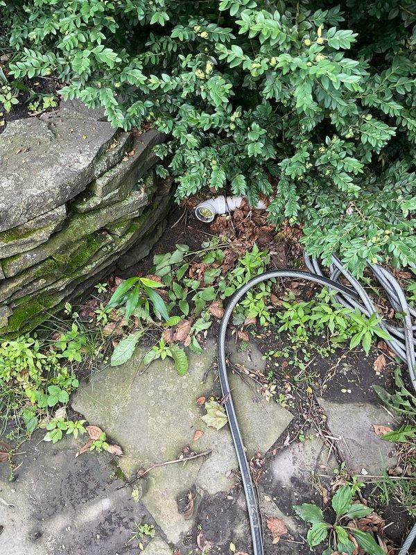 Responded to a clogged toilet that had been non-functional for one week in a century-old residential property. Upon arrival, assessed the plumbing system and determined the blockage required access to the main drain line. Located and accessed the exterior cleanout point through landscaped area, utilizing cable equipment to clear the obstruction. Successfully cleared the blockage and restored proper drainage function. Verified system operation and completed restoration work at pipe penetration points with appropriate sealing materials.
