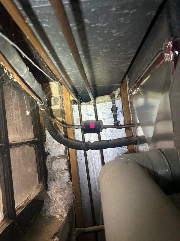 Responded to service call for non-functioning tanked water heater with active leak in basement of 80-year-old residence. Upon inspection, identified failed burner assembly with significant corrosion and deterioration at combustion chamber. Disassembled burner unit and removed defective thermocouple component. Assessed water heater condition in confined utility space with limited access, noting aged infrastructure and compromised burner integrity. Documented equipment failure through photographic evidence showing corroded burner disc and failed safety components. Leak source traced to tank failure related to prolonged operational issues over four-day period.