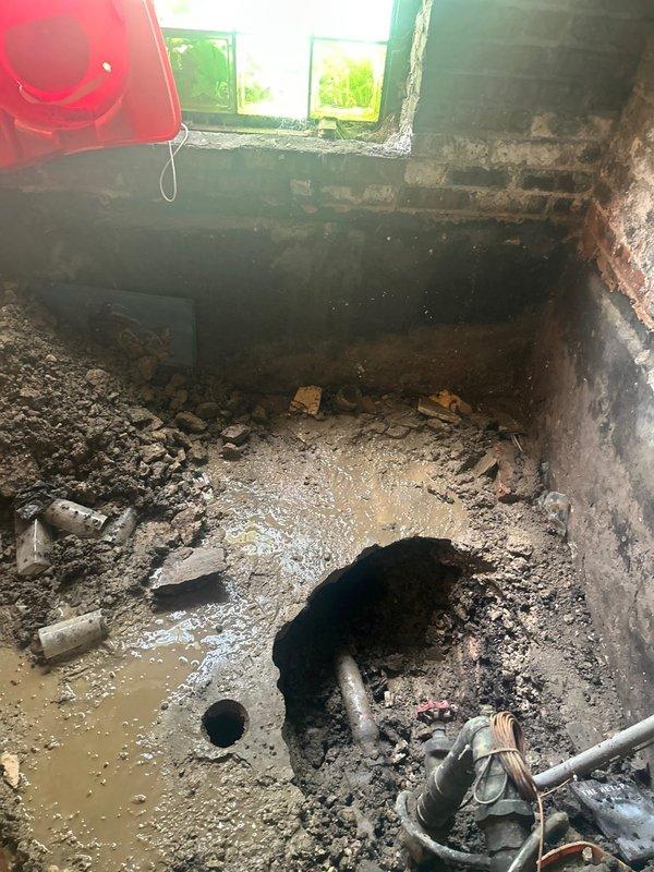 Responded to emergency service call for complete building water outage due to broken main water line. Upon arrival, conducted site assessment and documented conditions through photographic evidence. Excavation revealed compromised main water line beneath concrete floor with significant structural damage to surrounding foundation and flooring materials. Observed extensive water intrusion in basement area with standing water, sediment accumulation, and moisture damage to brick and concrete walls. Existing plumbing infrastructure showed deterioration from prolonged water exposure. Prepared comprehensive estimate for main water line replacement, including excavation of damaged concrete flooring, removal and replacement of failed water service line, restoration of foundation integrity, and remediation of water-damaged basement area with proper drainage considerations.