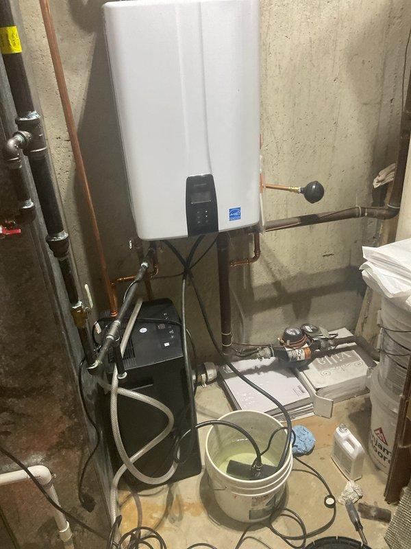Completed comprehensive VIP maintenance service including tankless water heater inspection, sump pump evaluation, and general home plumbing system assessment. Inspected tankless water heater unit mounted in basement utility area, verified proper operation of all connections, examined copper supply lines and gas connections for leaks or wear, and confirmed recirculation pump functionality. Assessed sump pump system operation and conducted visual inspection of all accessible plumbing components throughout the mechanical room to ensure system integrity and identify any potential maintenance concerns.