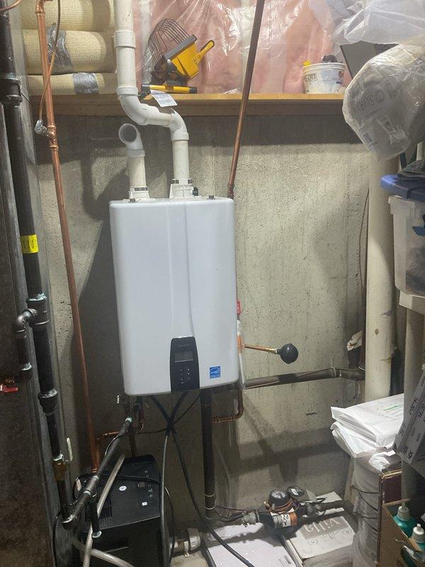 Completed comprehensive VIP maintenance service including tankless water heater inspection, sump pump evaluation, and general home plumbing system assessment. Inspected tankless water heater unit mounted in basement utility area, verified proper operation of all connections, examined copper supply lines and gas connections for leaks or wear, and confirmed recirculation pump functionality. Assessed sump pump system operation and conducted visual inspection of all accessible plumbing components throughout the mechanical room to ensure system integrity and identify any potential maintenance concerns.