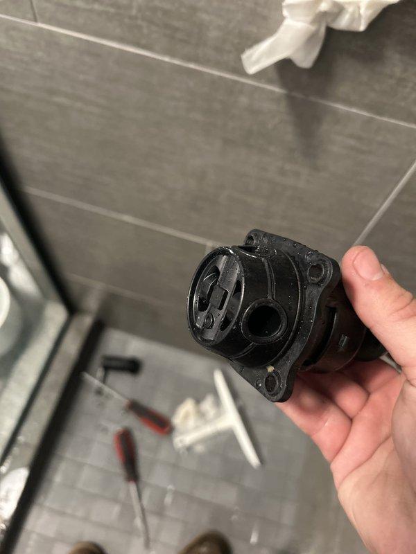 Responded to a no-water condition at shower fixture. Upon inspection, determined the issue was a failed shower valve cartridge rather than a blockage. Created access point through tile wall to reach the valve assembly, removed the defective cartridge mechanism, and installed replacement component. Restored full water flow to the shower and verified proper operation before closing the work area.