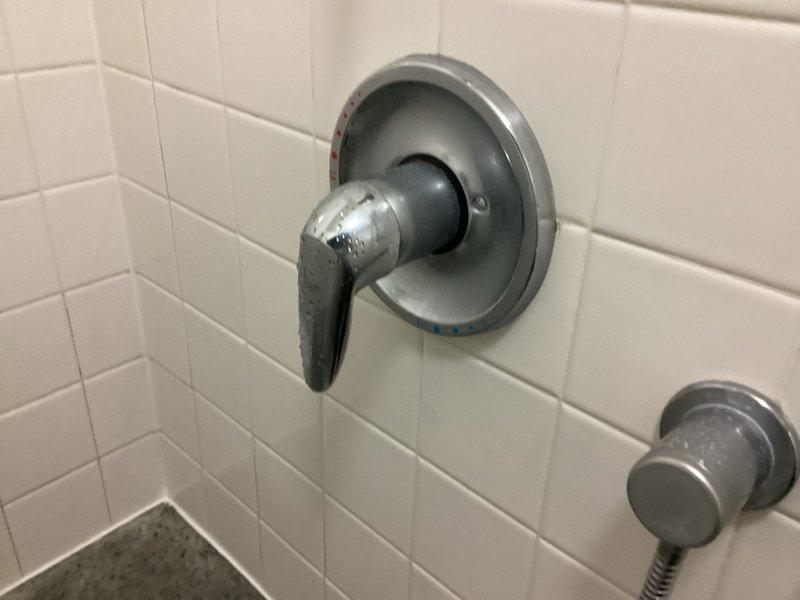 Responded to service call for two leaking Grohe bathroom shower fixtures. Upon inspection, identified water leakage at both shower valve assemblies mounted on white subway-tiled walls. Examined chrome-plated Grohe shower control handles and trim escutcheons, noting moisture accumulation and active dripping at valve interfaces. Documented existing conditions with detailed photography showing modern single-lever shower controls with circular mounting plates and handheld shower brackets. Assessed valve cartridges, seals, and trim components for wear and deterioration. Provided estimate for repair options including cartridge replacement, seal renewal, and potential valve body service to restore proper function and eliminate leaks at both fixtures.