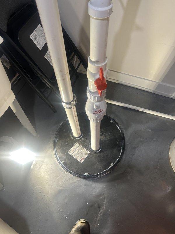 Responded to service call for ejector pump running continuously with water backing up into the pit. Upon inspection, found ejector pump system with visible moisture accumulation and deterioration of surrounding insulation materials. Assessed PVC discharge piping, check valve assembly, and pit conditions to diagnose flow restriction issue causing constant pump cycling and inadequate drainage.