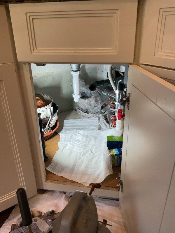 Responded to a kitchen drain clog that began the previous day in a century-old residence. Upon arrival, accessed the cabinet space beneath the kitchen sink and inspected the drainage system, which included a garbage disposal unit and P-trap assembly constructed of PVC piping. Cleared the obstruction from the affected drain line, restoring proper water flow and drainage function. Verified system operation and confirmed no leaks were present in the plumbing connections before completing the service call.