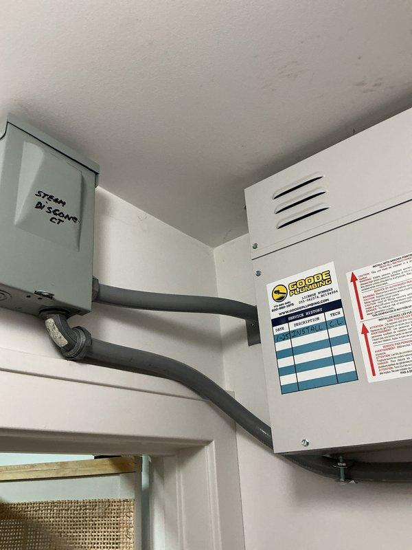 Inspected steam generator system connected to shower/tub installation. Documented brass valve fitting and connections on Steamist unit, noting weathered condition of brass components with visible patina. System requires further assessment and consultation to determine next steps for completion or repair.