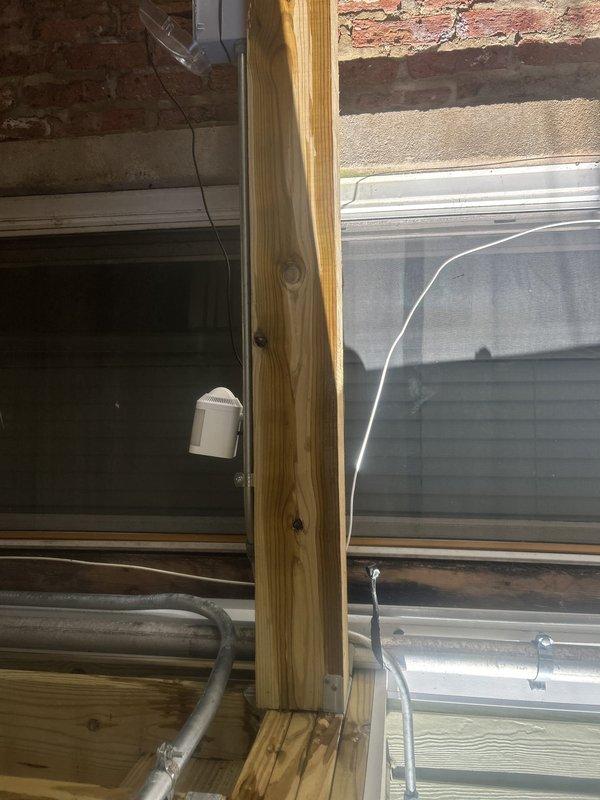 Responded to emergency call for water intrusion from unknown source in basement utility area. Upon inspection, identified active leak originating from compromised pipe connection near foundation window well. Isolated water supply to affected section and performed temporary shutoff to prevent further water damage to exposed wooden framing and structural elements. Traced moisture infiltration along HVAC ductwork pathway and basement window framing where discoloration on horizontal beams indicated prolonged exposure. Repaired burst section of piping, replaced damaged fittings, and restored water flow to system. Verified all connections for proper seal and tested system under full pressure to confirm repair integrity with no additional leaks detected.