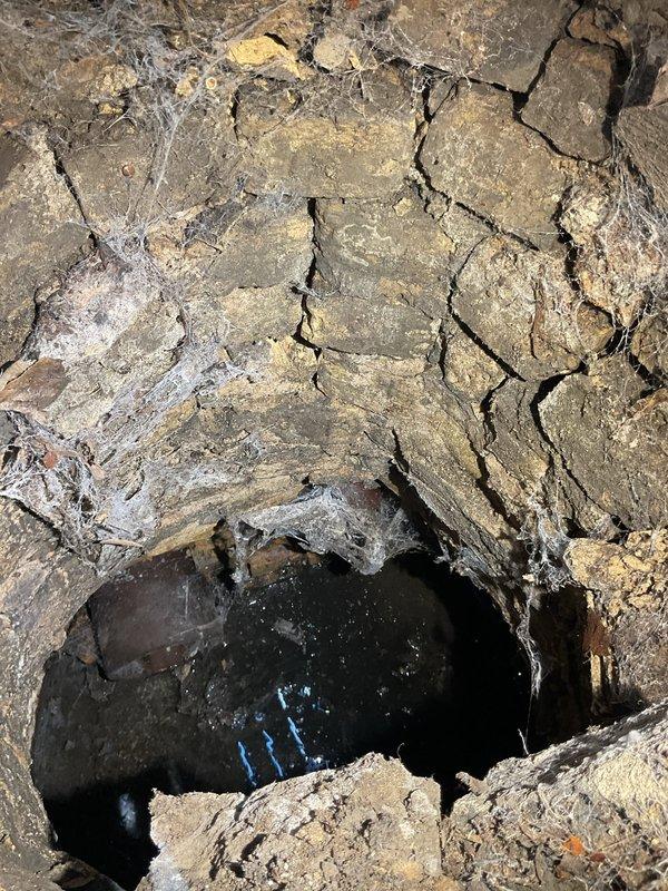 # Work Performed

Responded to service call for second floor toilet experiencing slow drainage and backup issues. Upon inspection, identified compromised drain line requiring attention. Removed and replaced existing toilet with new unit, ensuring proper seal and secure mounting on existing flange.

Conducted video inspection of main sewer line from structure to street connection to assess overall system condition and identify potential concerns. Camera inspection revealed deteriorated section of main drain line with visible cracking, structural failure, and soil infiltration. Documented findings showing significant pipe degradation requiring repair or replacement to prevent future backup issues and potential property damage.

Completed toilet installation in second floor bathroom featuring beadboard wainscoting and octagonal tile flooring. Tested new fixture for proper flush operation, verified adequate water flow, and confirmed no leaks at supply connection or wax ring seal. Provided 