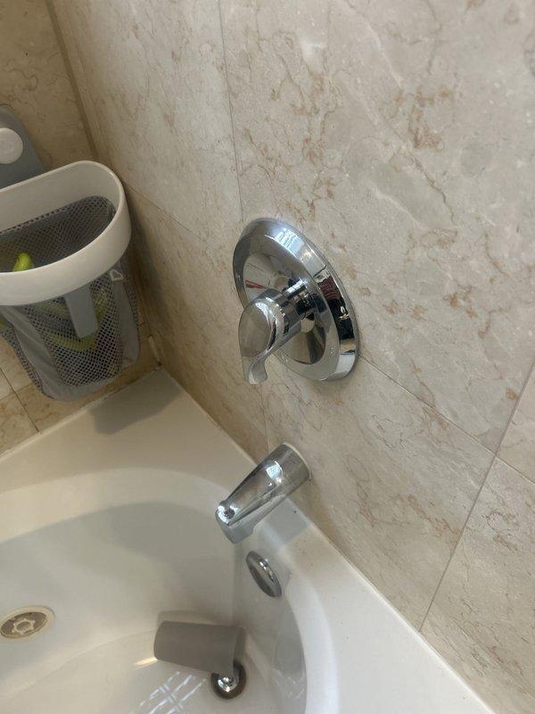 Responded to same-day service request for shower valve cartridge replacement. Customer had been unable to remove shower handle due to stripped mounting screw. Accessed the shower valve assembly through the tiled wall, removed the damaged hardware, and successfully installed the customer-supplied replacement cartridge. Restored full functionality to the shower control valve and completed necessary reassembly of the fixture.