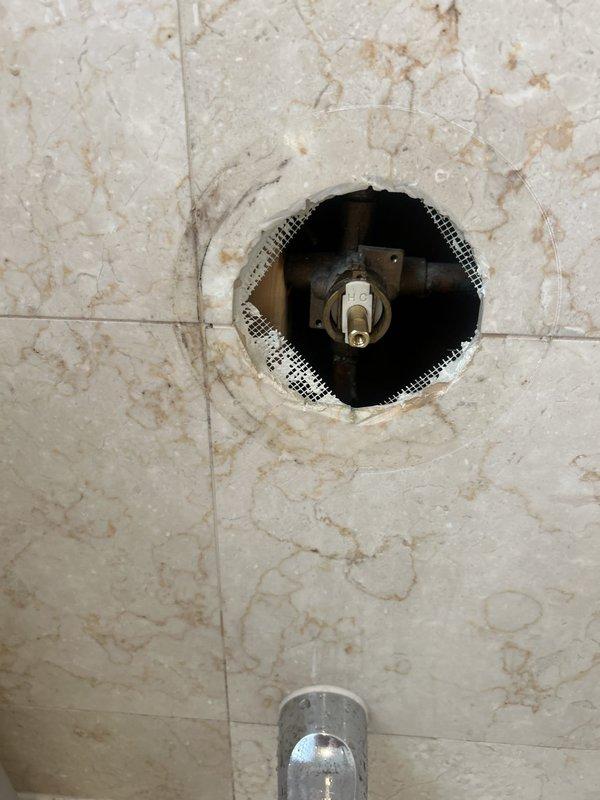 Responded to same-day service request for shower valve cartridge replacement. Customer had been unable to remove shower handle due to stripped mounting screw. Accessed the shower valve assembly through the tiled wall, removed the damaged hardware, and successfully installed the customer-supplied replacement cartridge. Restored full functionality to the shower control valve and completed necessary reassembly of the fixture.