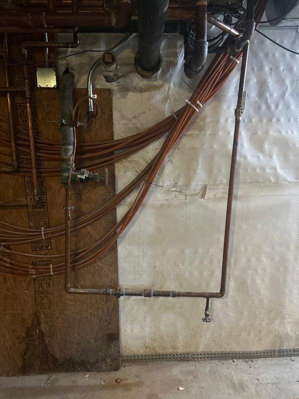 Completed comprehensive plumbing system upgrade including lead testing and hydrojetting services. Installed new copper piping throughout basement mechanical space with proper bundling and routing, coordinating with existing HVAC ductwork and electrical systems. Protected work area with drop cloths during installation and documented all work with photographs for quality assurance records.