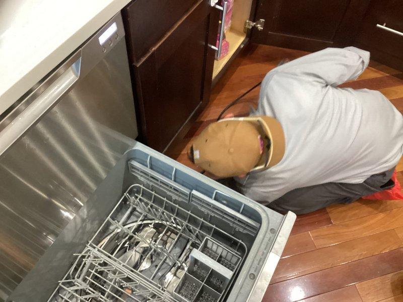 Responded to water leak investigation affecting unit below, with suspected source from kitchen dishwasher or sink area. Performed thorough inspection of dishwasher installation, surrounding cabinetry, and under-sink plumbing connections to identify leak origin. Documented findings with photographic evidence of kitchen plumbing system and affected areas for customer review.