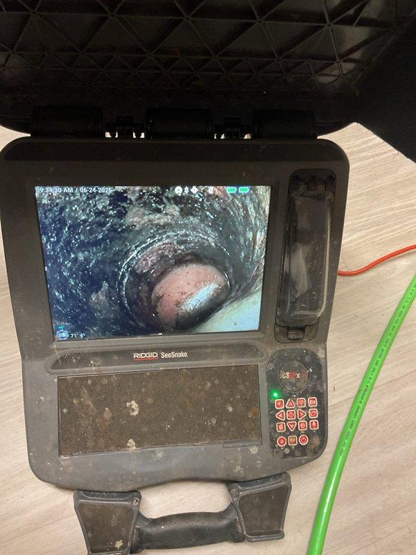 Responded to emergency call for main drain backup causing sewage overflow throughout building drains, bathrooms, and kennel areas. Upon arrival, deployed pipe inspection camera equipment to assess the main sewer line and identify the source and extent of the blockage. Utilized professional-grade drain cleaning equipment including power threading machine and specialized cutting tools to access and clear the obstruction in the main drainage system. Performed video inspection of pipe interior to confirm complete blockage removal and verify proper flow restoration. Successfully cleared the main line backup, restoring full drainage function to all affected fixtures and preventing further sewage infiltration into the facility.