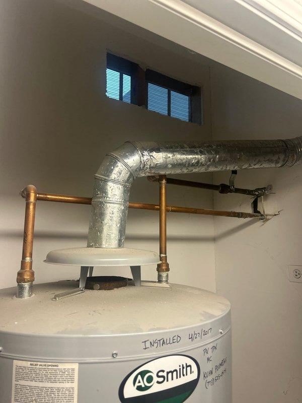 Responded to customer request for water heater replacement estimate. Upon arrival, inspected existing AO Smith water heater located in basement mechanical room, noting installation date of April 25, 2017 marked on unit. Evaluated current water heater condition, examined copper supply line connections, and assessed surrounding utility space configuration. Documented existing equipment specifications and installation setup including proximity to HVAC ductwork and ventilation systems. Photographed water heater unit with visible manufacturer labeling and existing plumbing connections to provide accurate estimate for replacement. Reviewed access route through residential hallway to determine equipment delivery path and installation logistics. Provided customer with comprehensive estimate for water heater replacement including removal of existing unit and installation of new equipment.