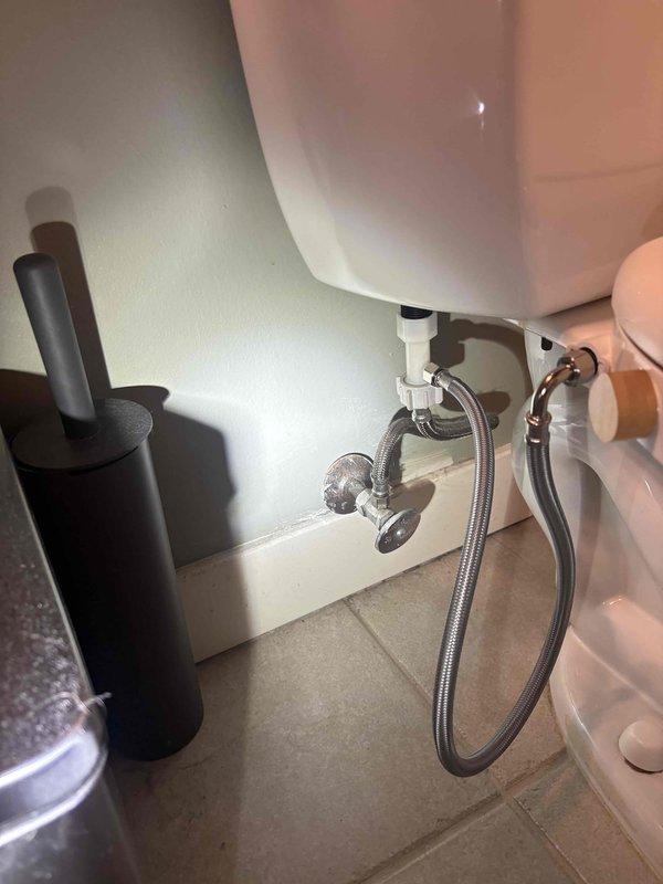 Responded to multiple plumbing leak concerns including kitchen and bathroom sink valve replacements, bathtub faucet repair, and toilet tank seal issues. Coordinated water shut-off with building management to safely replace leaking angle stop valves beneath kitchen sink and bathroom vanity. Inspected and documented existing plumbing configurations including P-trap assemblies, braided supply lines, garbage disposal connections, and wall-mounted shut-off valves. Assessed moisture accumulation around bathtub area to provide diagnostic evaluation and recommendations. Photographed under-sink plumbing conditions showing chrome fixtures, flexible supply lines, and drain assemblies for documentation purposes.