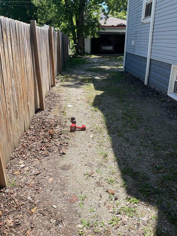 Performed video camera inspection of residential sewer line to evaluate system condition and identify the point of connection to the main. Accessed sewer line through available cleanout in narrow side yard area between house and fence, navigating equipment through confined workspace with gravel and dirt surface. Successfully completed camera inspection of the entire sewer lateral, documenting findings with video footage to provide accurate assessment for repair or replacement recommendations.