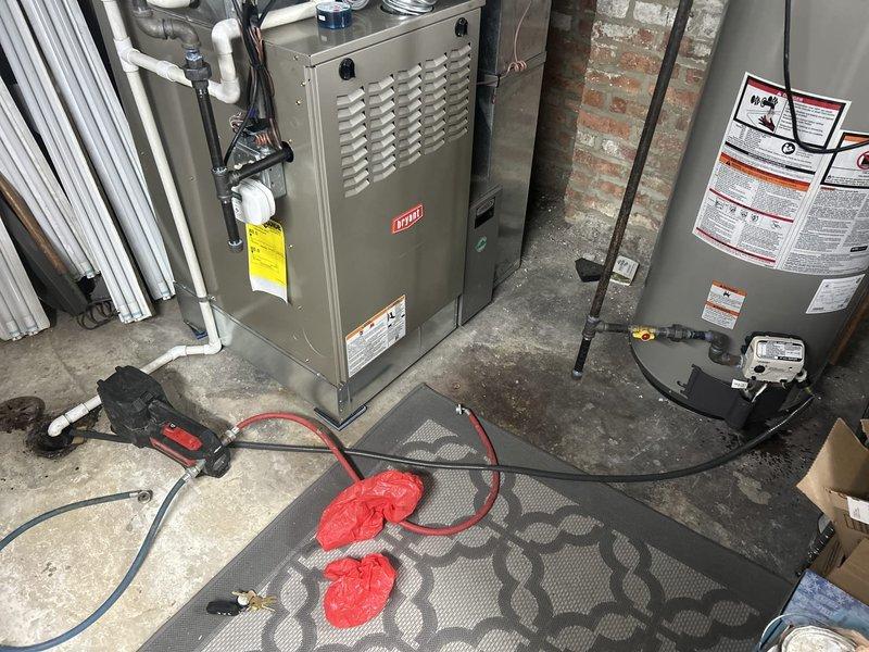 Completed routine VIP plumbing maintenance including comprehensive water heater flush on gas-fired unit located in historic home basement with exposed brick foundation and aging plumbing infrastructure. Inspected water heater connections, piping, and safety systems; verified proper operation of temperature and pressure relief valve; flushed sediment buildup from tank to maintain efficiency and extend equipment lifespan.